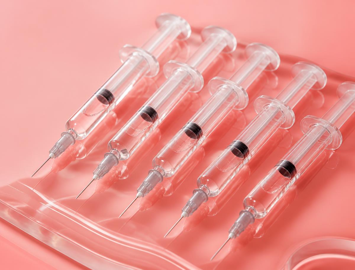 Dermal filler treatment at Petro Facial Plastic Surgery Hyaluronic acid dermal filler syringes arranged on a coral background, representing 20% off filler treatment in Birmingham, Alabama